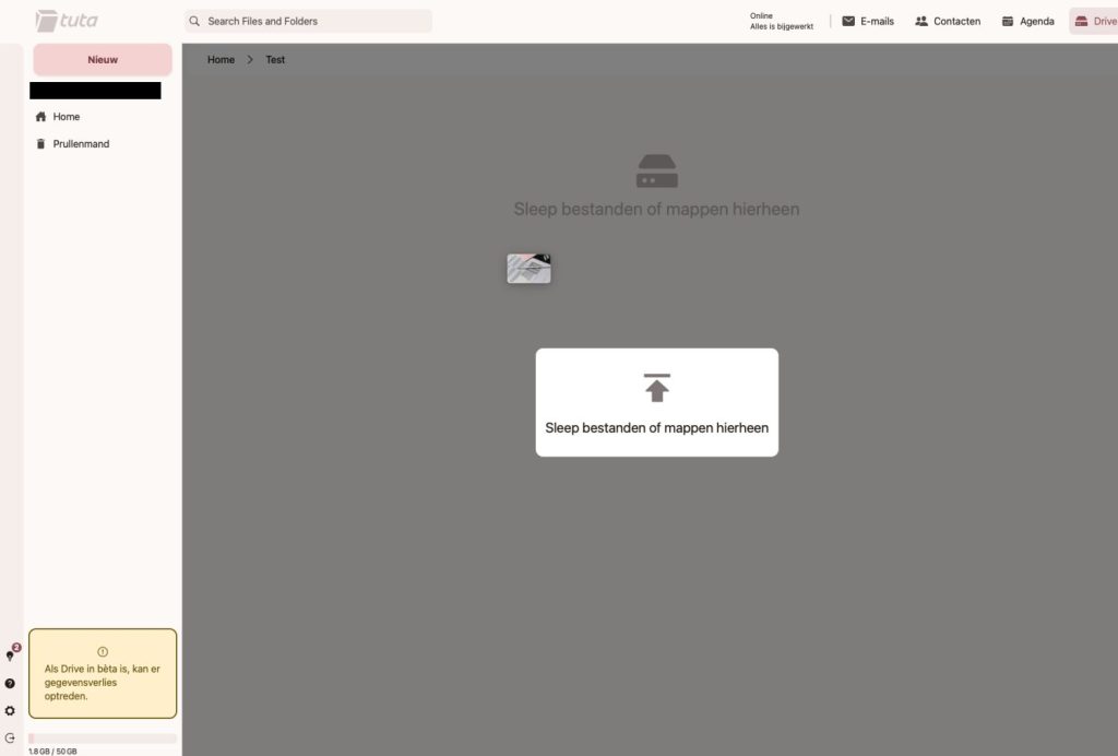 Tuta Drive drag and drop upload in action, showing an image being dragged into the Test folder with an upload overlay visible